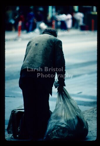 Man with Garbage Bag and Suitcase