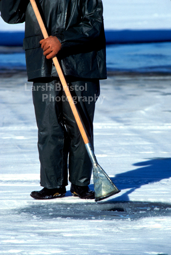 Man Drilling Ice Fishing Hole